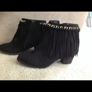 Black suede with fringes.